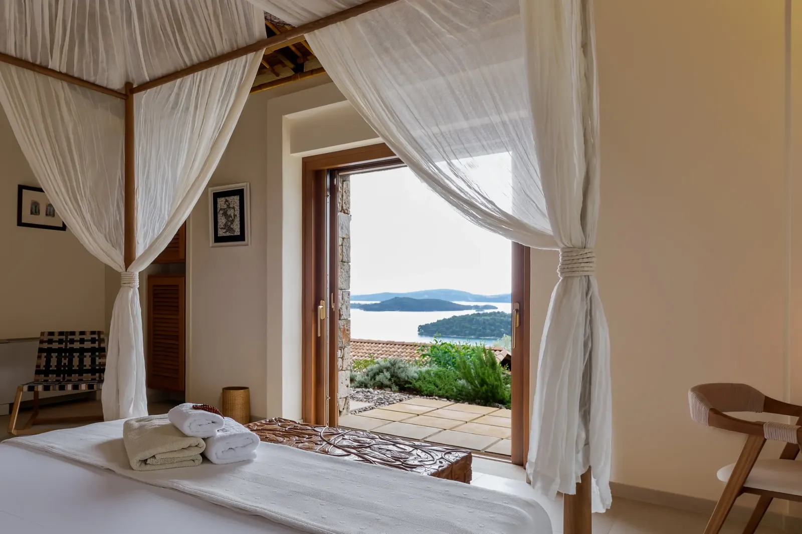 A bedroom at Mimosa, its doors open to the Ionian Sea